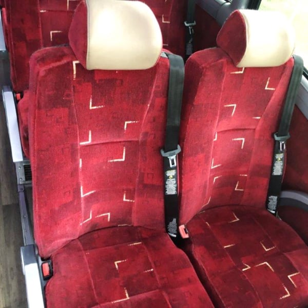 MCI 56 Passenger bus with Red Seats. Detail of seats.